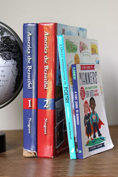 homeschool books beside a globe