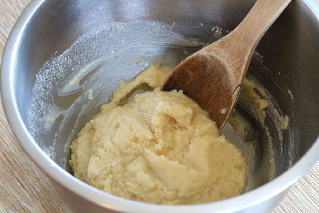crust dough in a bowl with wooden spoon