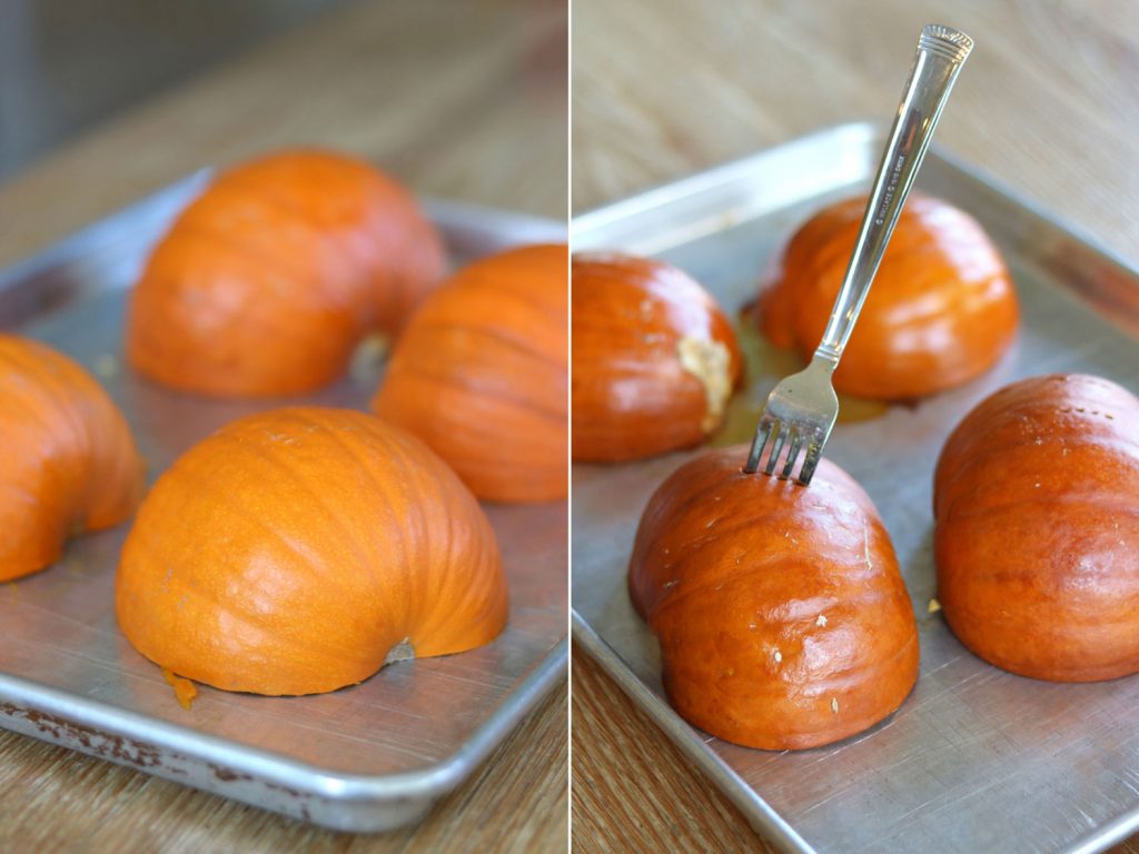 sugar pumpkins cut in half on a sheet pan