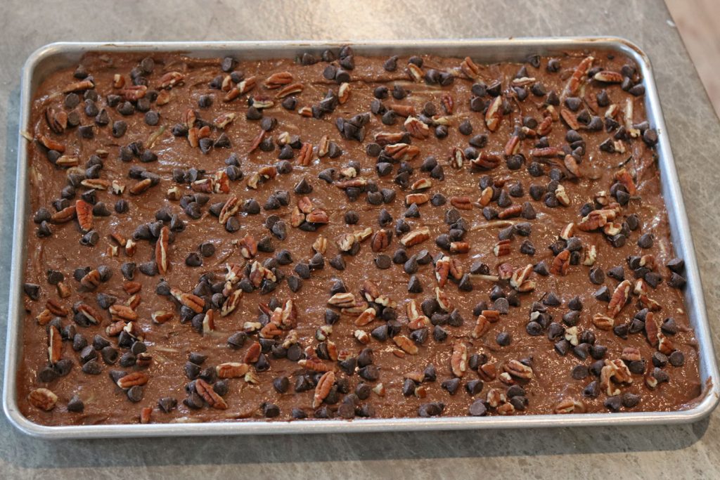 chocolate zucchini cake with chocolate chips and nut in a jellyroll pan