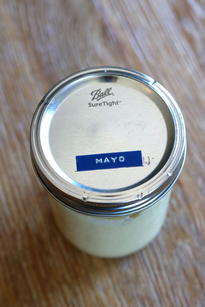 Homemade avocado oil mayo in a glass mason jar.